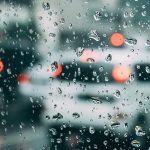 a view through the windshield during the rain with a new windshield replacement